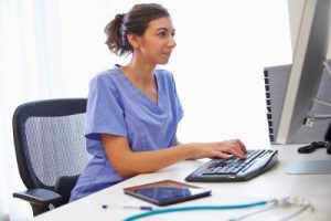 Nurse sitting at computer desk