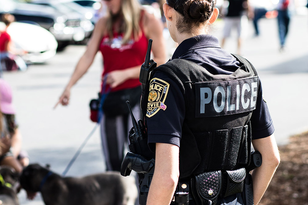 female Law enforcement Officer walking towards a crowd