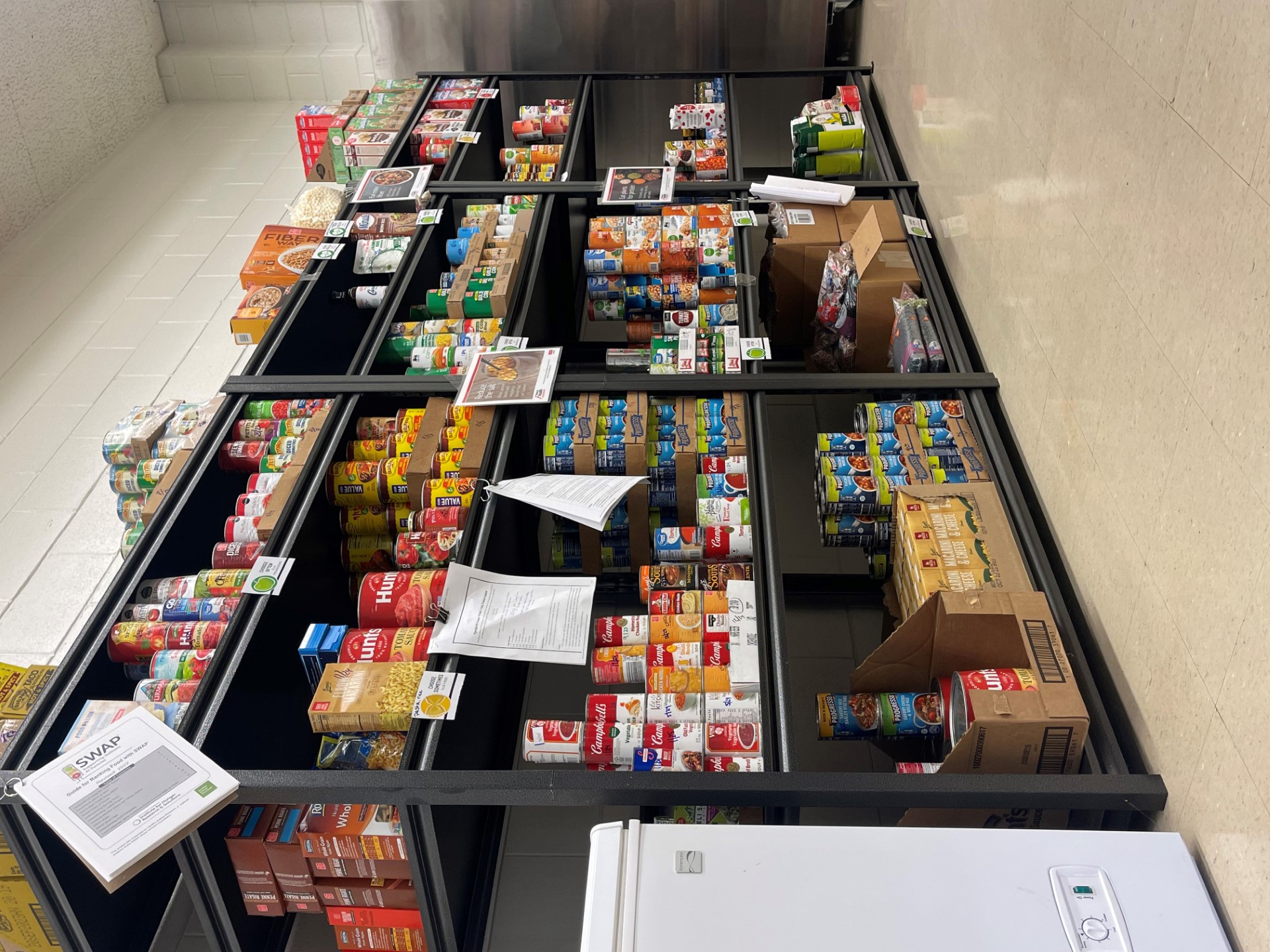 Food pantry shelves filled with a variety of goods.