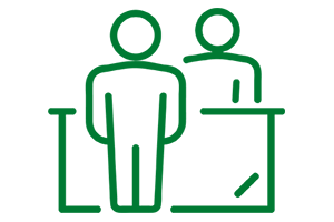 Clip art of two people standing with a desk between them.