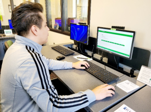 A Student uses one of the computers in the Career Services area to fill out an assessment.